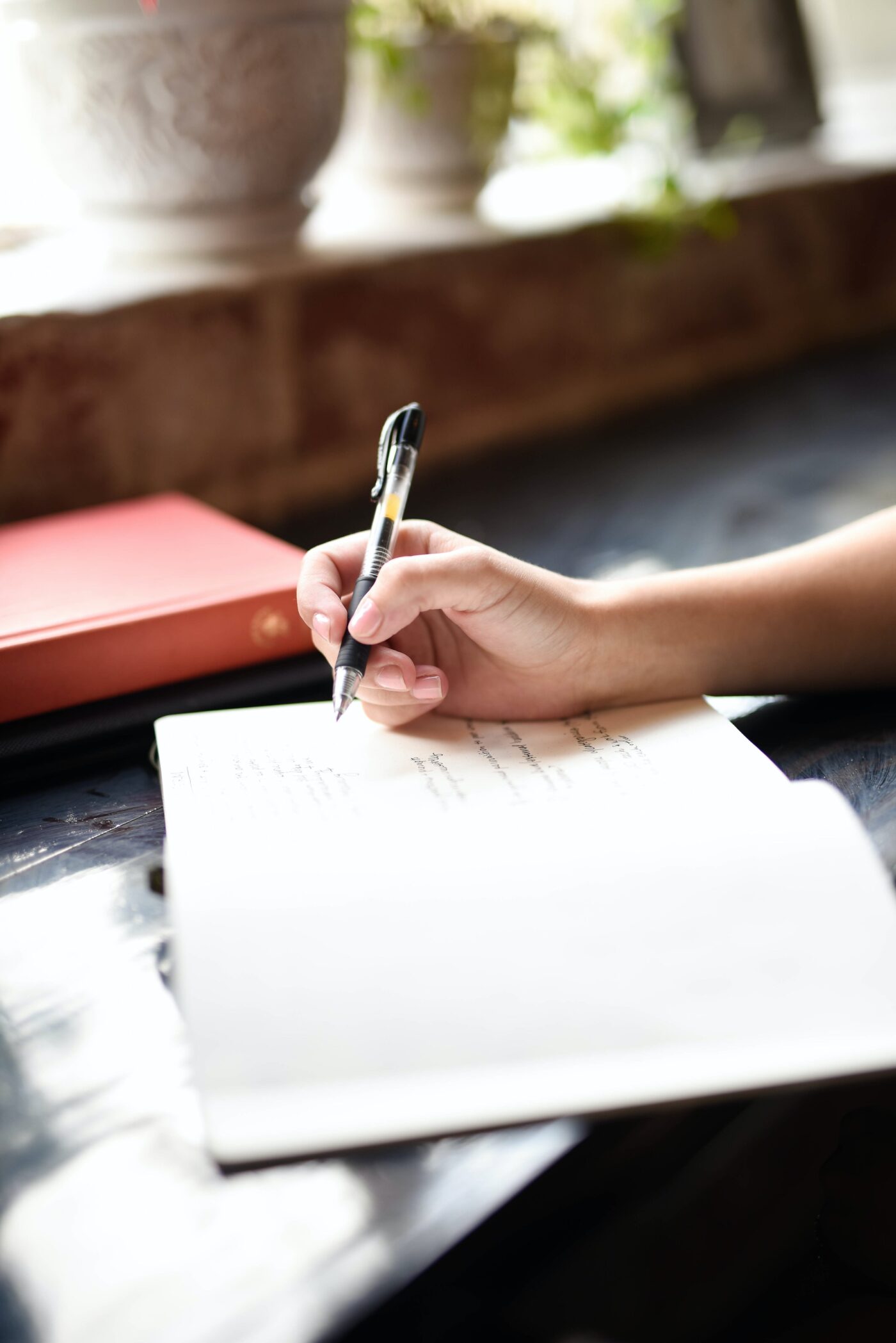 A hand signing a paper